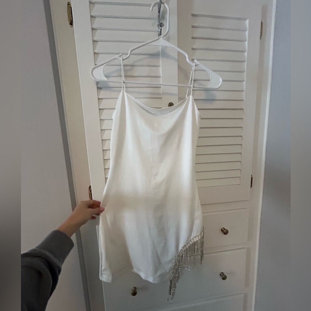 White fitted dress with dangling sequins on the side